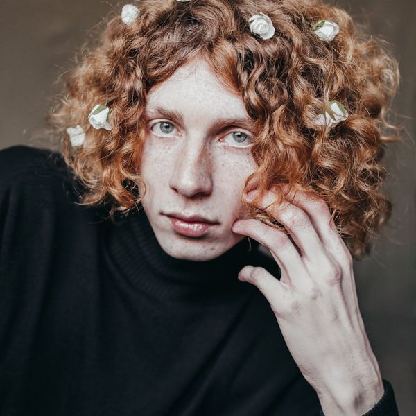 A person meditating peacefully with a calm expression on their face.